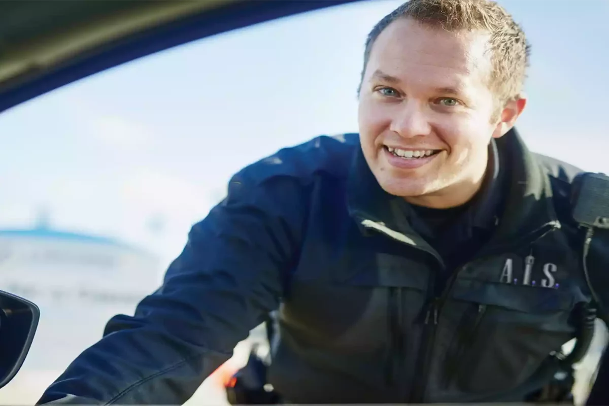 AIS Security greeting someone in a car